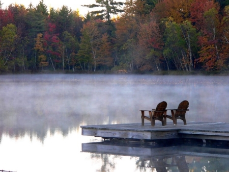 two chairs at end of dock in morning fog