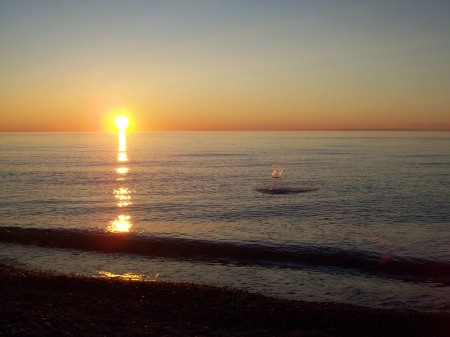 Skipping stones at sunset