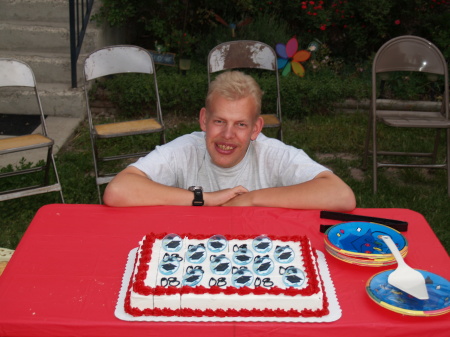 RUSTY AT HIS GRADUATION PARTY BY HIS CAKE