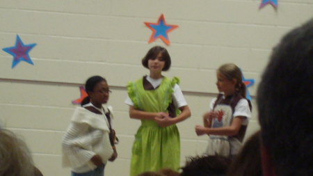 Emily in green gifted program performance