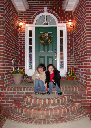 Girls on front step Christams Eve