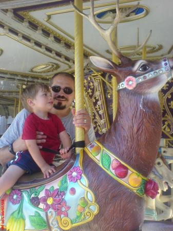 Taking Paul on his first carousel ride.