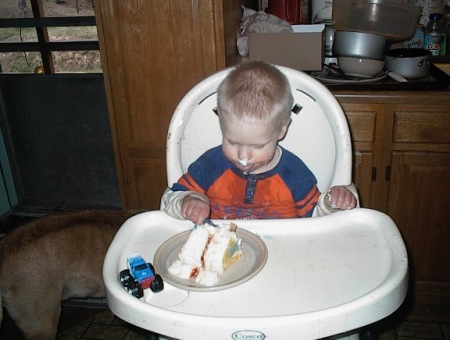 Jayson cutting a bite of cake