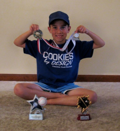 Adam showing off his baseball trophies.