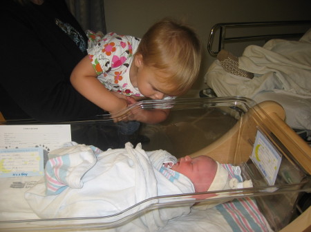 My granddaughter looking at her new baby bothe