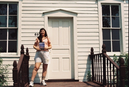 Cheryl in front of a One Room School House