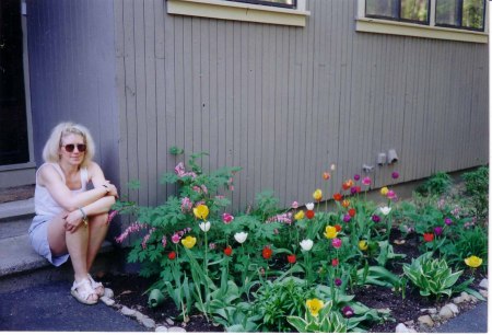 Susan with tulips by condo in Woodbury