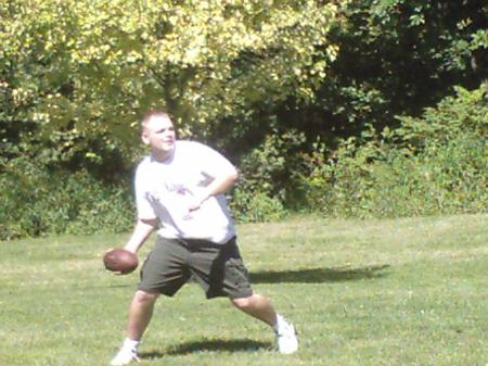 Jason plays QB at the company picnic.