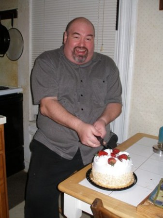 John cutting his cake