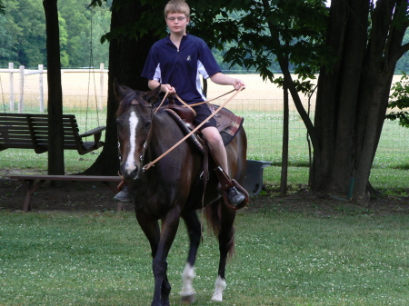 Alex riding Cheyenne in the back yard