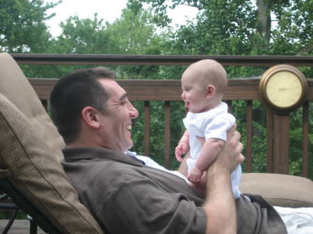 Daddy holding Hannah on our deck.