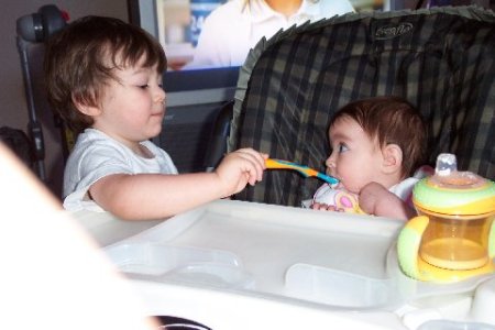 Alex feeds his sister Kylie