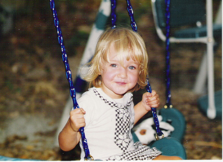 Sophia swinging and happy after chocolate cake