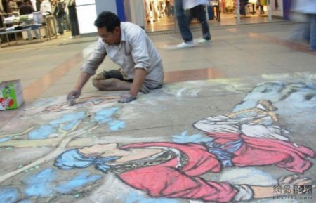 William painting on a sidewalk