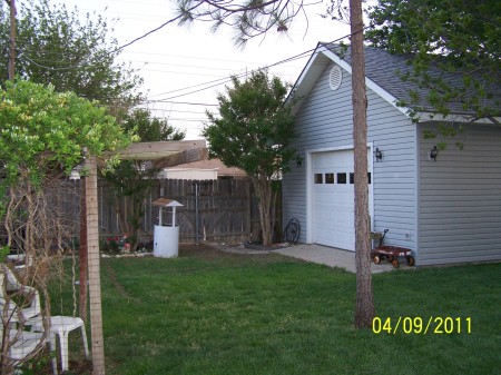 east end of the shop.   alley behind the fence