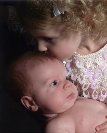 Chloe(2) kissing her new little brother Caden