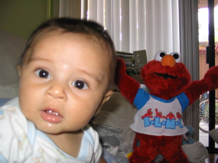 Baby Mario hanging with his biddy Elmo