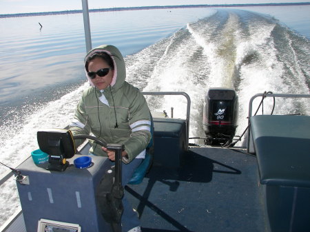 Arlene driving the boat at Lake Marion