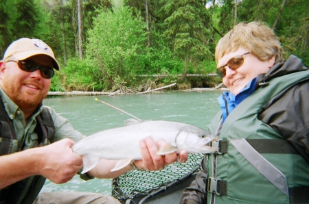 Aunt Linda with a fishing guide and a fish.