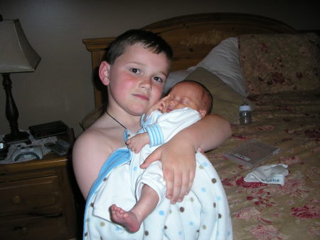 Jacob holding his new brother.