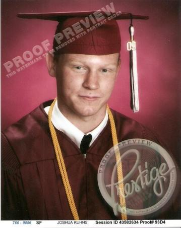 Josh in his cap, gown, and honor cord.