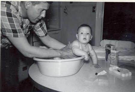 Dad giving me a bath as a toddler