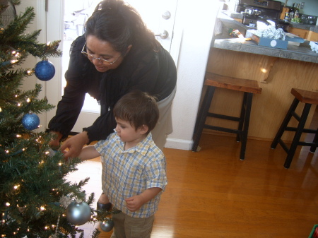 My mom and baby putting up the tree at  home