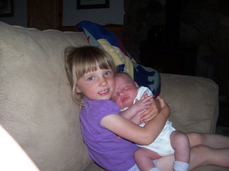 Sage holding her baby sister Jozie
