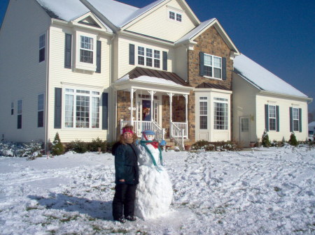 Cassie with a Snowman in front of House 2006