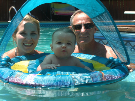 stephanie, charlotte and grandpa hanging out in the pool