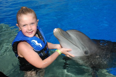 Maddie swims with dolphins