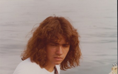 Me playin guitar on the dock.