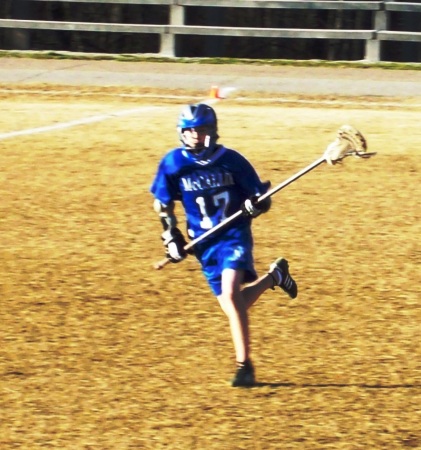 Mike playing lacrosse at school