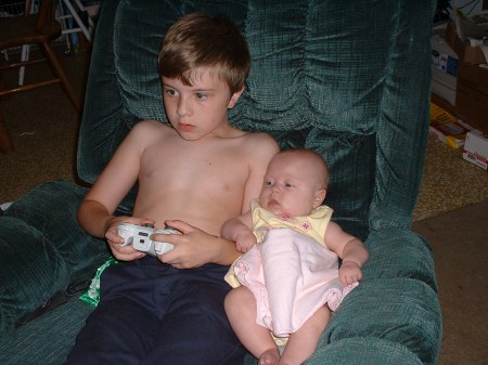 Lucas showing Phoebe how to enjoy video games.