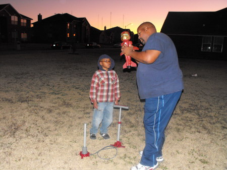 Jr and Sr outside playing with Iron Man