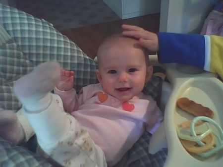 Laying in her high chair sideways