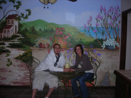 Vtio and girlfriend in front of Aunt's artwork