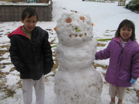 My two cute kids with their 1st snowman!!