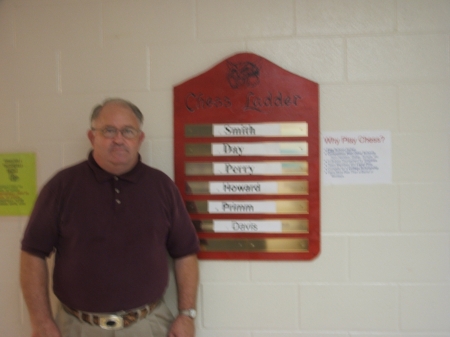 Eddie Payne next to Chess Ladder Board