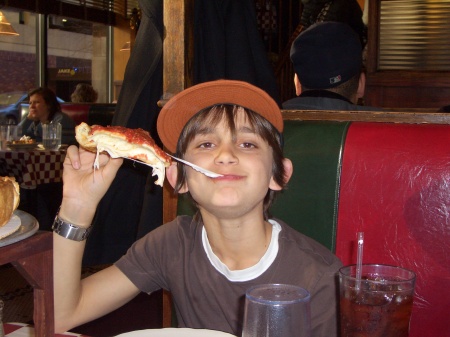 Alex (my son) enjoying Chicago stuffed pizza
