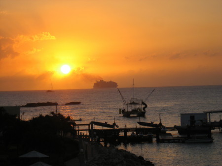 Cruise ship steams by at sunset