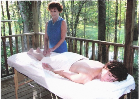 Massage therapy on porch of swamp cabin