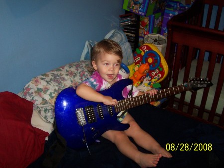 Playing dad's guitar.