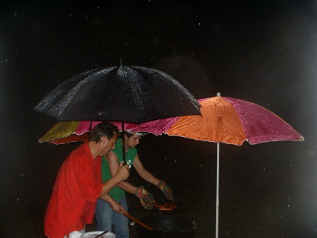 husband & son grilling in the rain