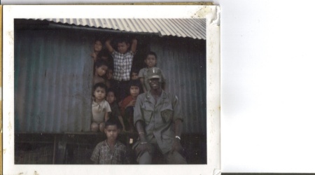 Al in front of Montagnard hut w/village kids