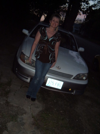 Lisa in front of her car.
