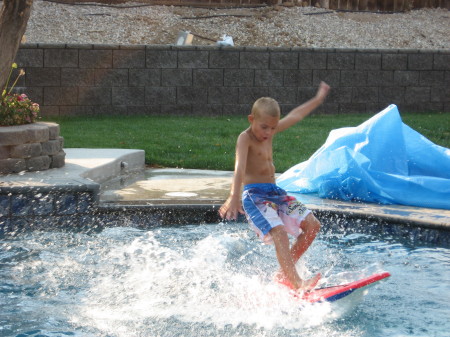 Tyler surfing in our pool