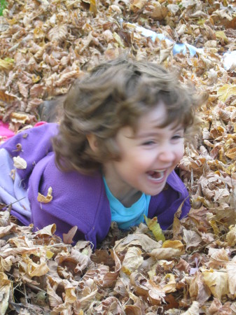 Sarah playing in the leaves