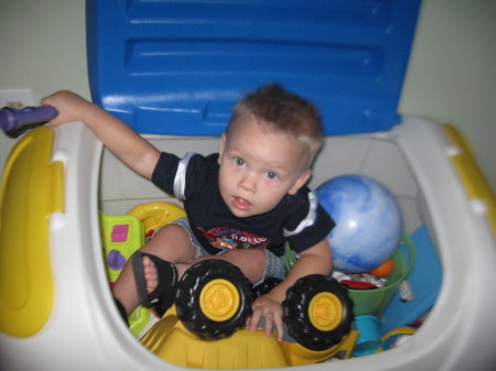 Zachary in his toy box