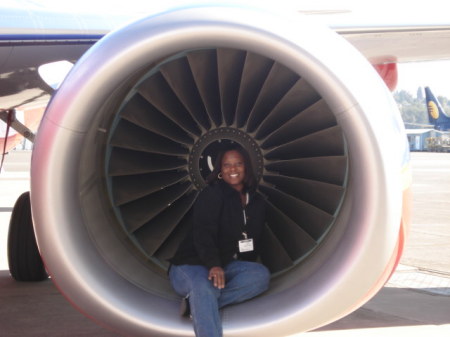 Me sitting in the engine of a plane.